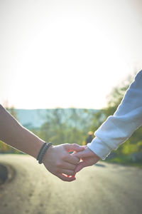 Cropped image of couple holding hands