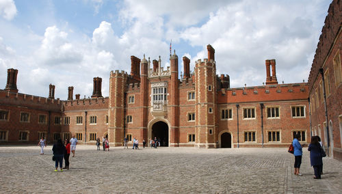 Group of people in historic building against sky