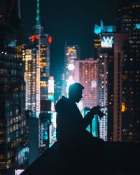 Silhouette of man in city at night