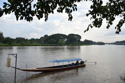 Boat in lake against sky