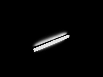 Close-up of illuminated lamp in darkroom