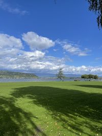 Scenic view of golf course against sky