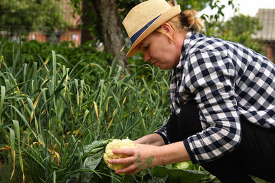 Side view of man gardening at farm