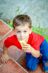 High angle portrait of boy eating food