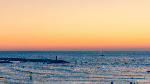 Scenic view of sea against clear sky during sunset