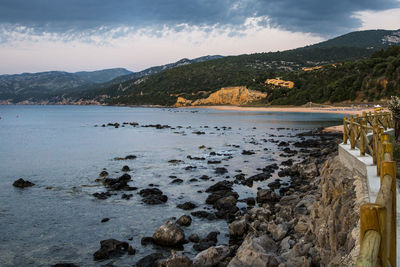 Scenic view of sea and mountains against sky