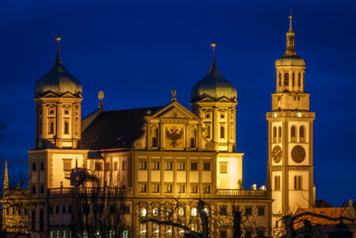 Low angle view of illuminated building against sky at night