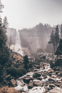 Scenic view of waterfall against sky