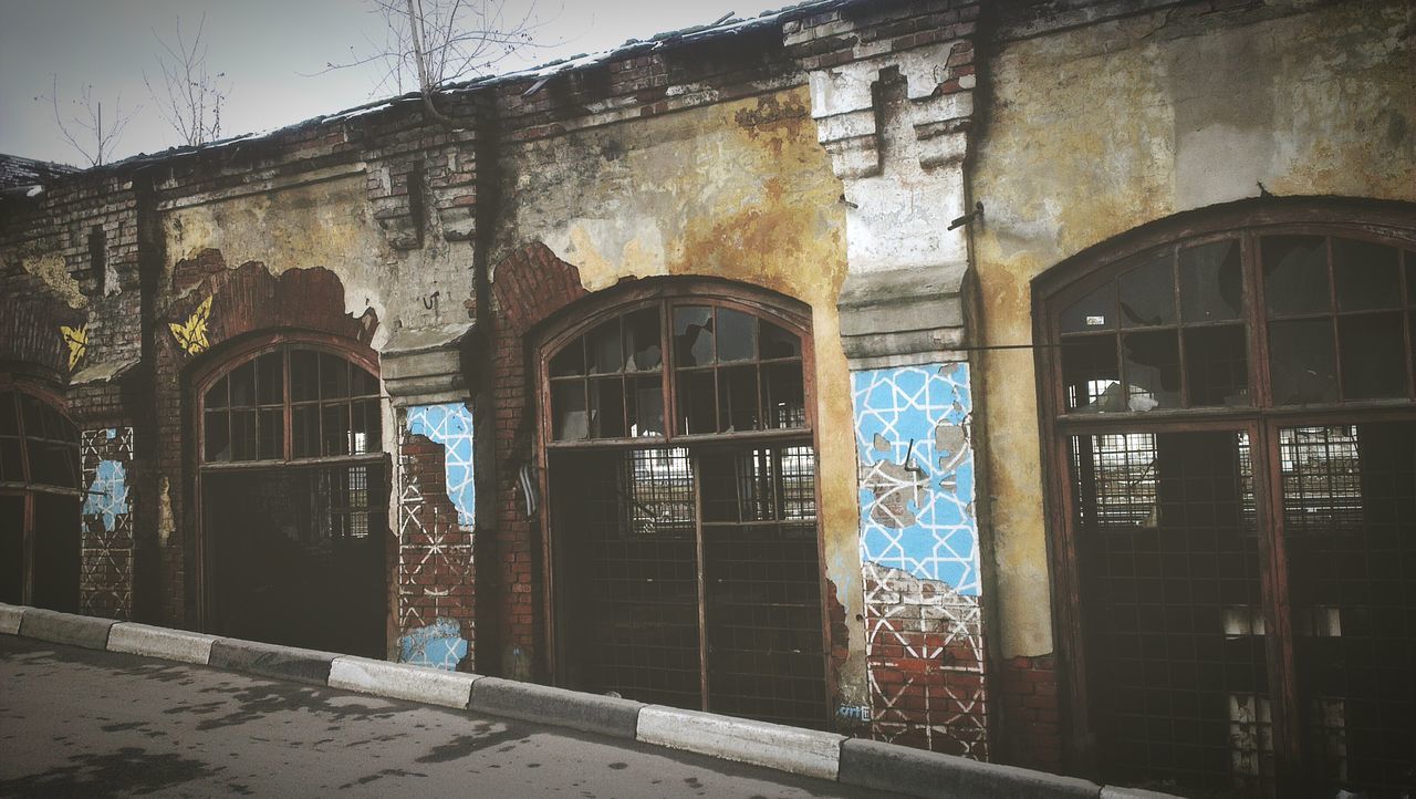 architecture, building exterior, built structure, window, house, residential building, building, residential structure, door, old, closed, entrance, abandoned, glass - material, day, outdoors, arch, city, reflection, no people