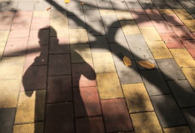 Shadow of people on footpath