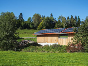 House on field against clear sky