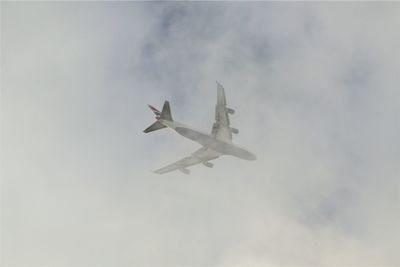 Low angle view of airplane flying in sky