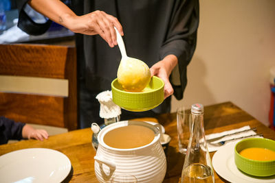 Midsection of man having food at table