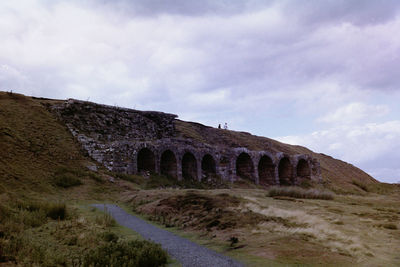 Built structure on land against sky