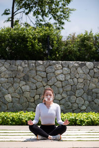 Beautiful chinese girl wearing n95 face mask while working out