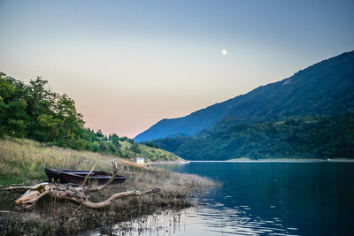 Scenic view of lake and mountains against sky