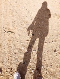 Shadow of man on sand