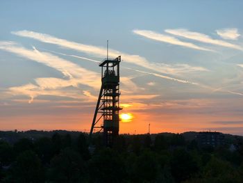 Silhouette tower against sky during sunset