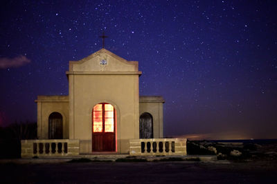 Low angle view of illuminated building at night