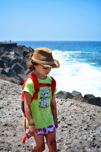 Full length of boy wearing hat on beach