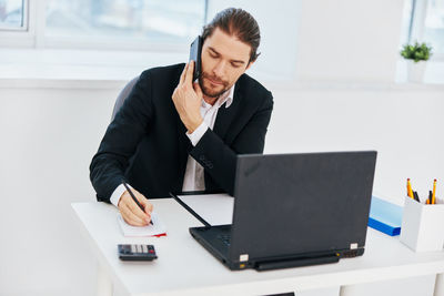 Mid adult man using laptop on table