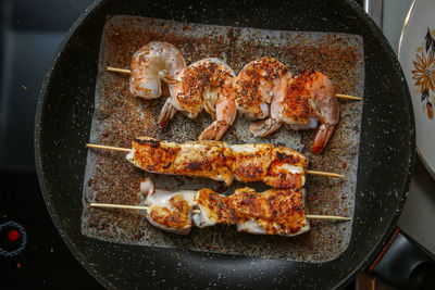 High angle view of meat on barbecue grill