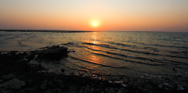 Scenic view of sea against sky during sunset