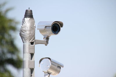 Low angle view of coin-operated binoculars against clear sky