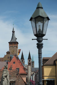 Low angle view of buildings and churchtowers in city of würzburg against sky