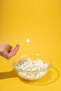 Midsection of person holding ice cream in bowl
