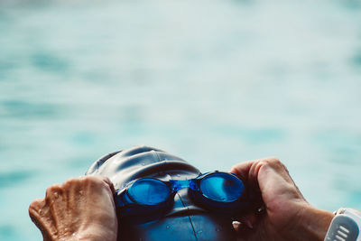 Close-up of man wearing swimming goggles in pool
