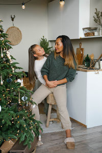 Happy family mom and daughter have fun preparing for christmas and new year in the kitchen