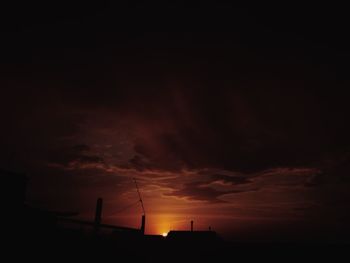 Low angle view of silhouette building against sky during sunset