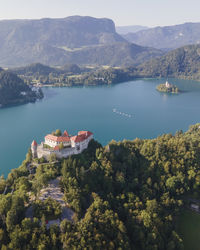 Aerial view of blejski grad, a beautiful castle built on top of a rock facing lake bled