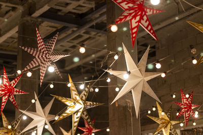 Low angle view of illuminated christmas lights hanging on ceiling