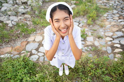 Smiling young nurse on field