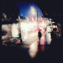 Blurred motion of woman in city at night