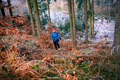 Full length of man walking in forest