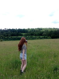 Full length of woman wearing hat on field