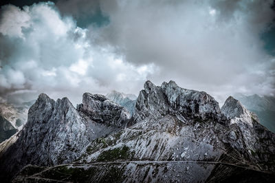 Scenic view of mountains against cloudy sky