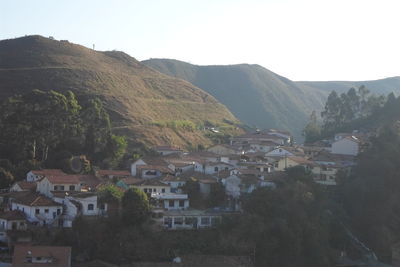 Houses in town against clear sky