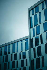 Low angle view of modern building against blue sky