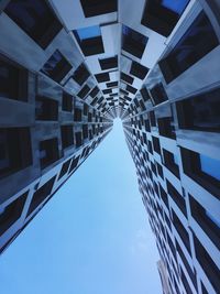 Low angle view of modern buildings against blue sky