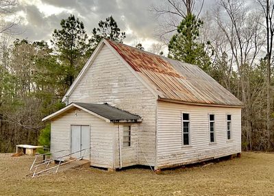 Old rural church building against a grey sky