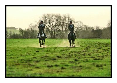 People walking on grassy field