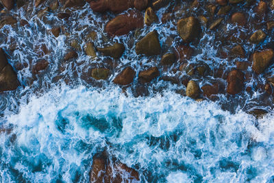 Full frame shot of water flowing through rocks