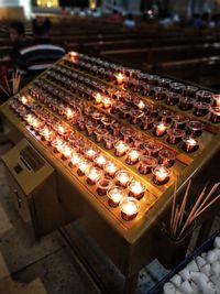 High angle view of illuminated candles on table