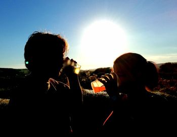 Silhouette people enjoying on field at night