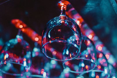 Low angle view of upside down wineglasses hanging from ceiling