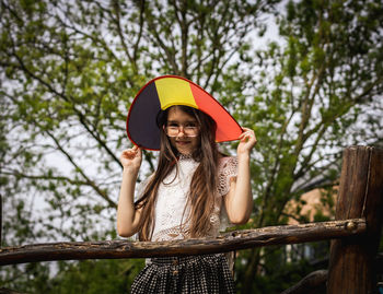 Portrait of a beautiful caucasian girl wearing a belgian flag hat.